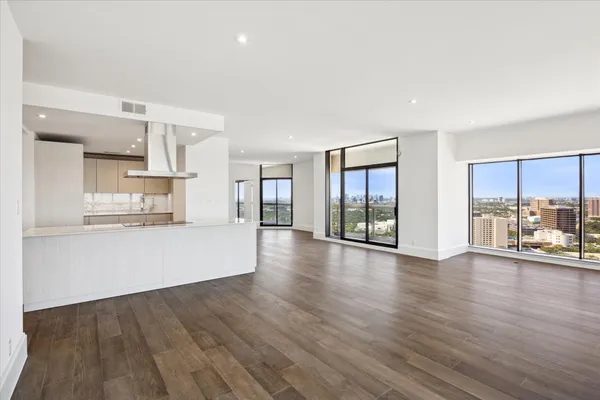 a view of a kitchen with wooden floor and a window