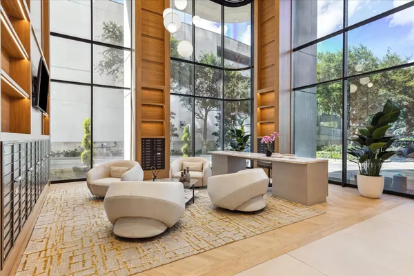 a living room with furniture and a floor to ceiling window