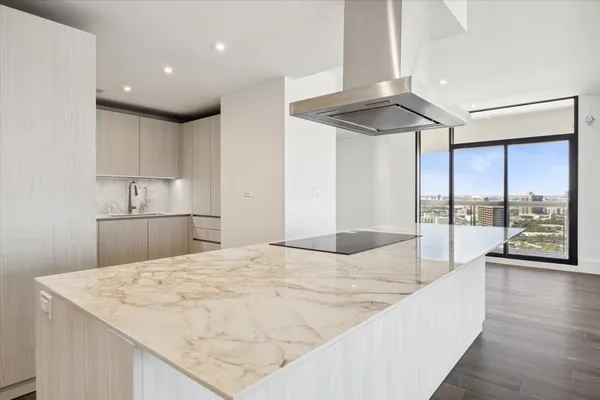 a kitchen with kitchen island a large counter top appliances and cabinets