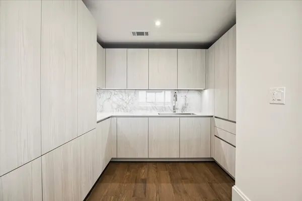 a kitchen with granite countertop white cabinets and white appliances