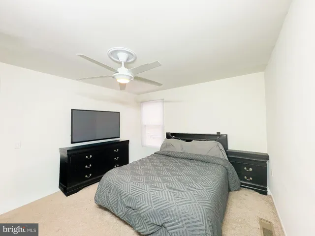 a bedroom with a bed and a tv