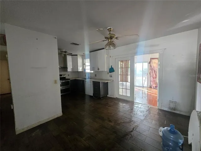 a view of a kitchen with a refrigerator a microwave and a sink