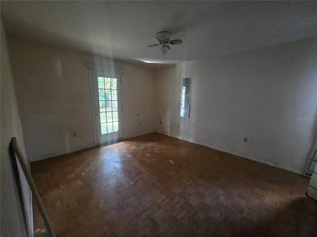 an empty room with windows and closet