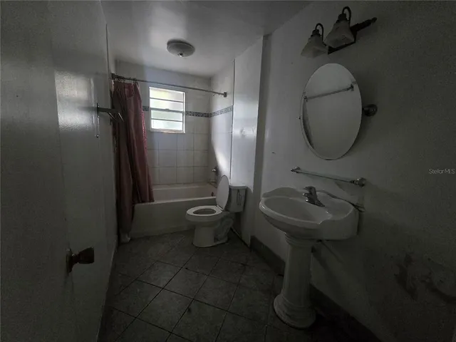 a bathroom with a sink toilet and a mirror