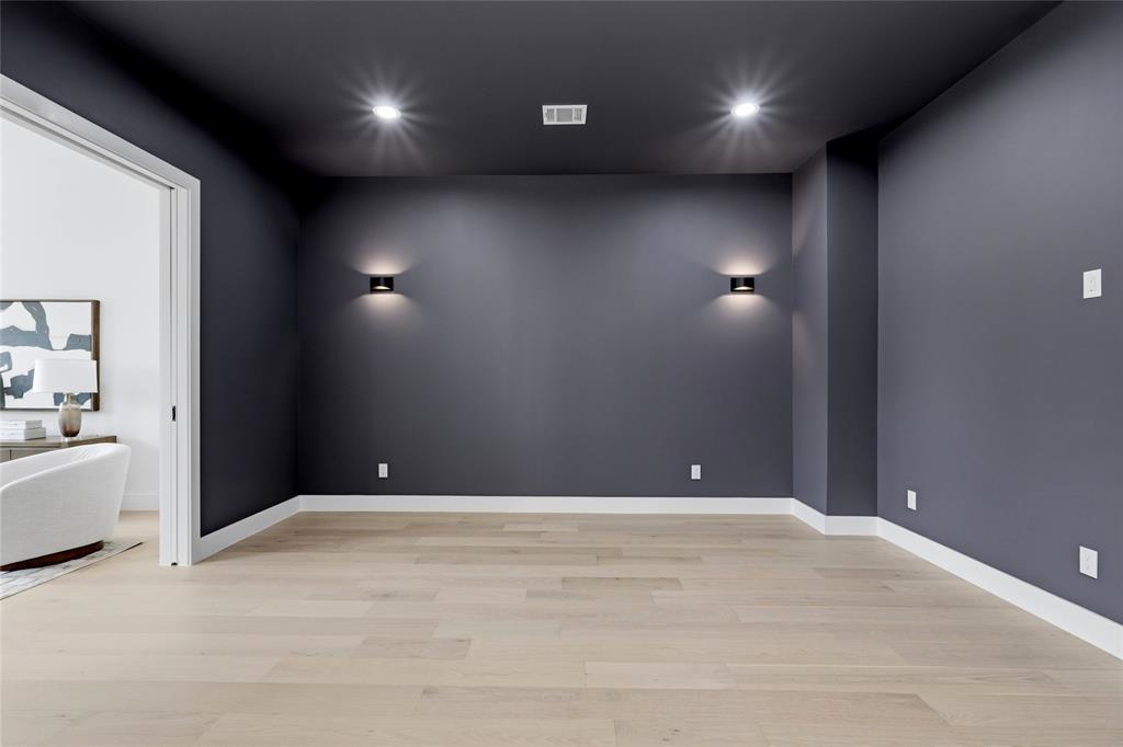 6038 Prospect Avenue Dallas, TX 75206 - Photo 32 of 40 Spacious room with dark gray walls, recessed ceiling lighting, and light wood-finish flooring