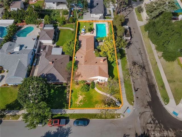 an aerial view of a house with a garden and swimming pool