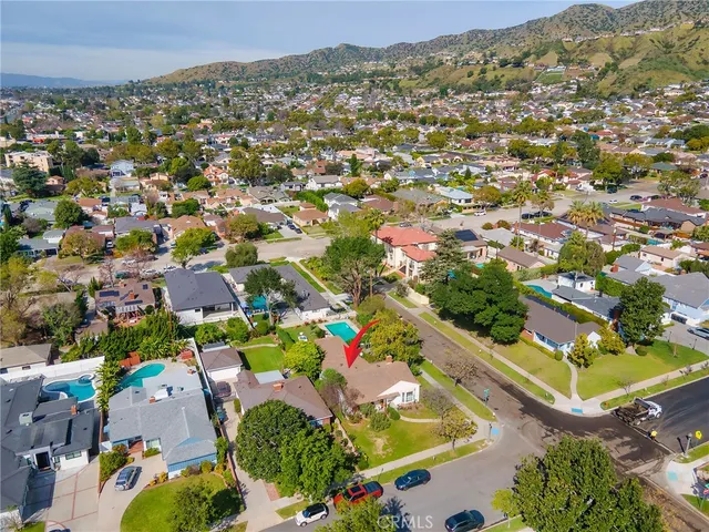 an aerial view of a house with a garden and yard