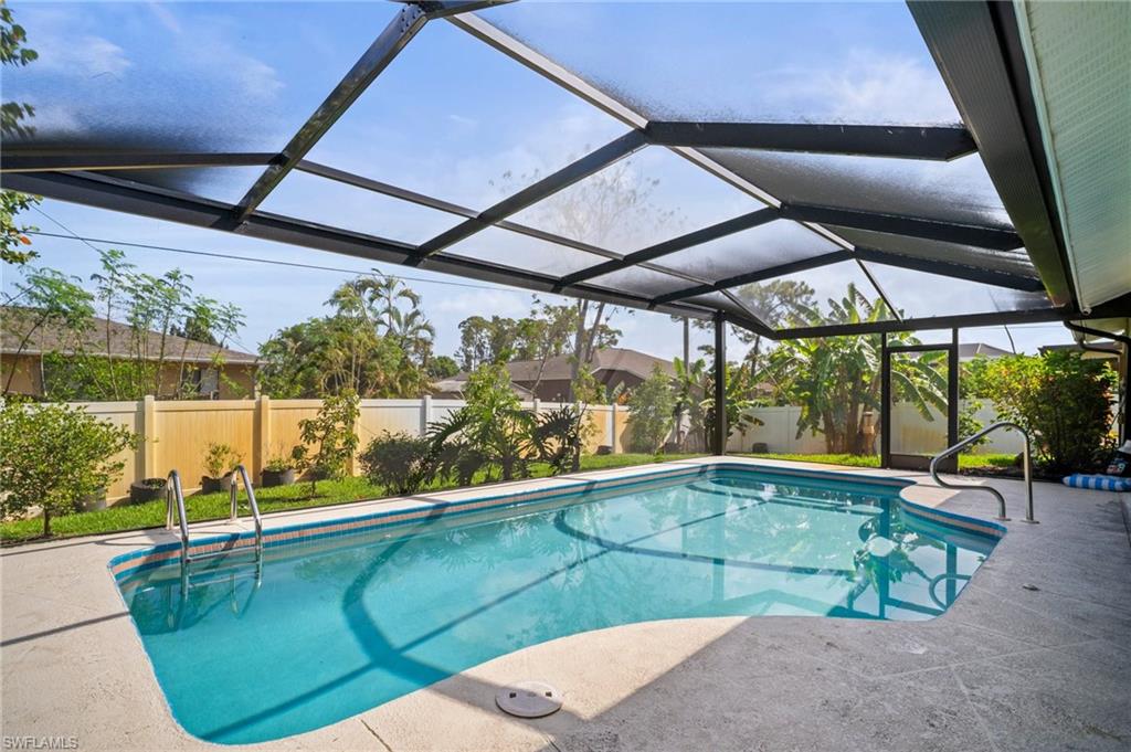 9061 Irving Road Fort Myers, FL 33967 - Photo 17 of 19 View of swimming pool featuring a fenced in pool, a patio, a fenced backyard, and glass enclosure