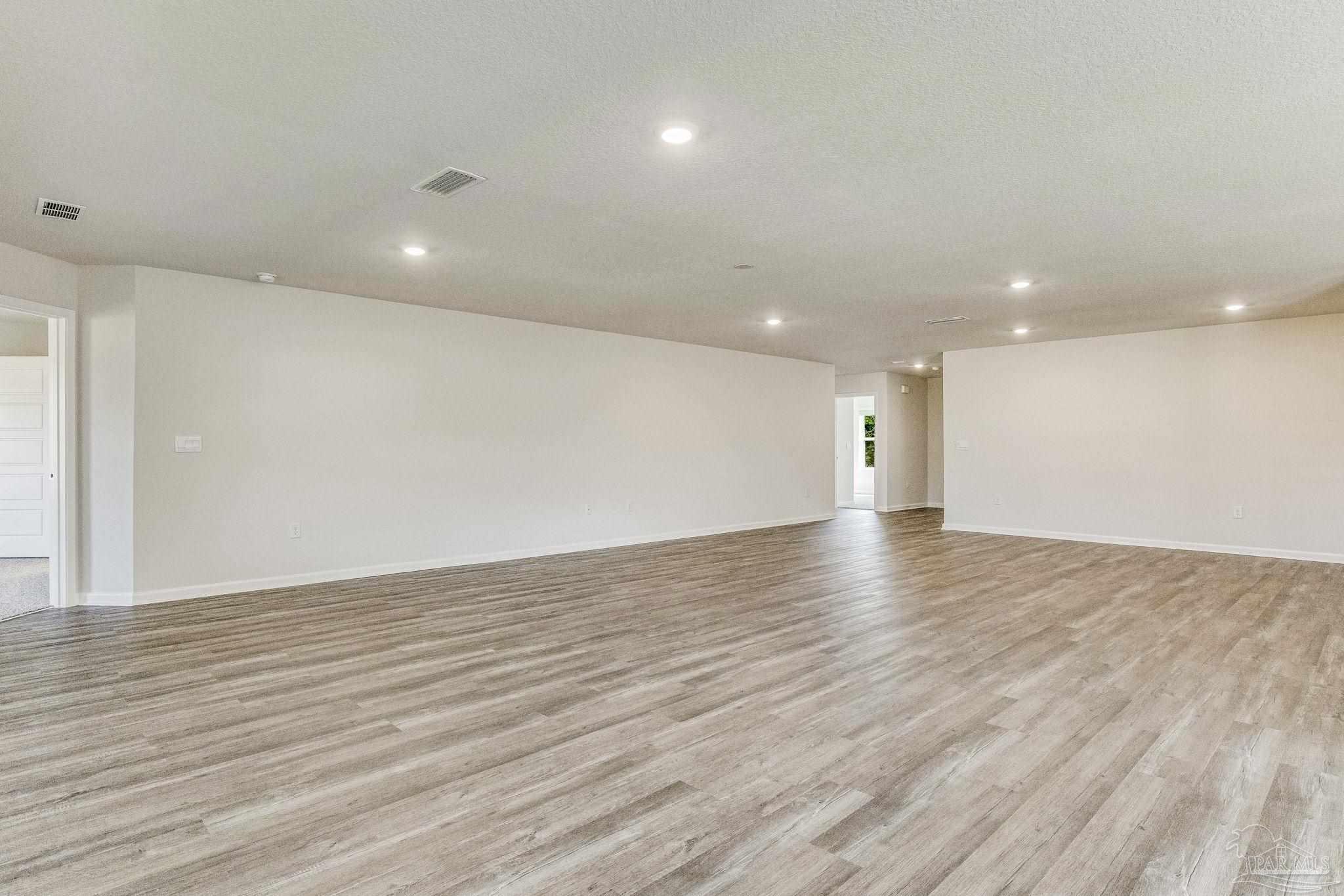 9823 MilleeLoop Loop Pensacola, FL 32526 - Photo 13 of 50 a view of an empty room with wooden floor and a window