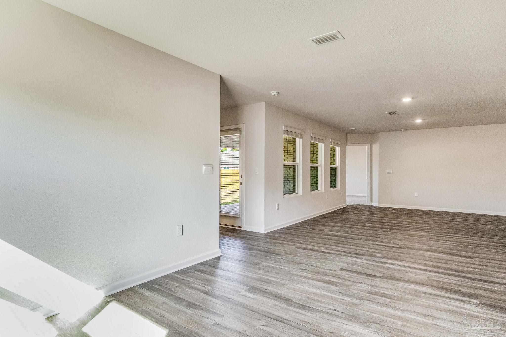 9823 MilleeLoop Loop Pensacola, FL 32526 - Photo 14 of 50 a view of an empty room with window and wooden floor