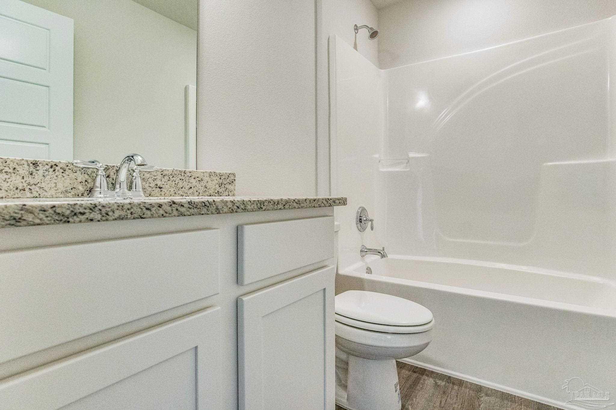 9823 MilleeLoop Loop Pensacola, FL 32526 - Photo 15 of 50 a bathroom with a granite countertop toilet sink a mirror and bathtub
