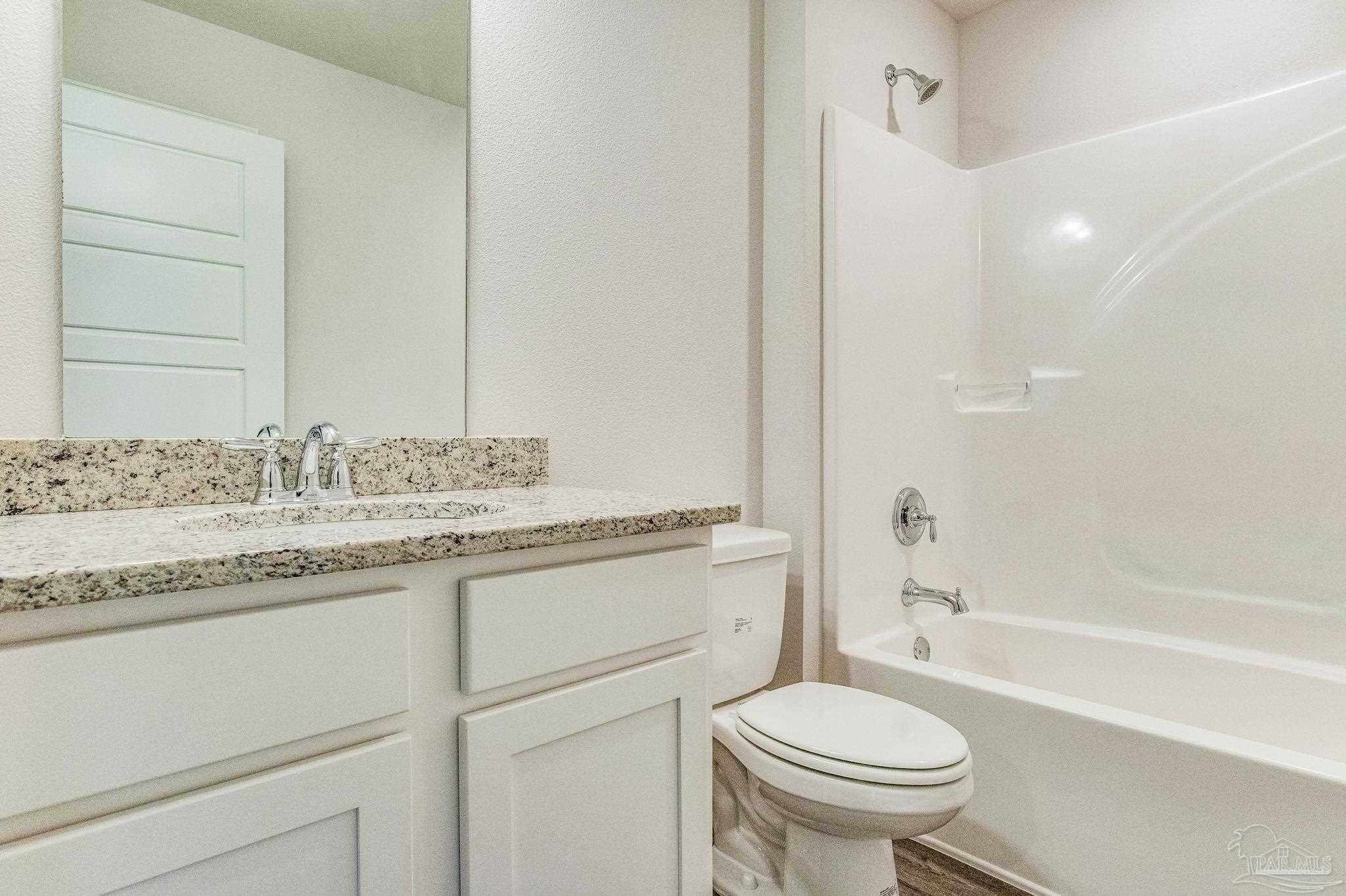 9823 MilleeLoop Loop Pensacola, FL 32526 - Photo 18 of 50 a bathroom with a granite countertop sink toilet mirror and bathtub