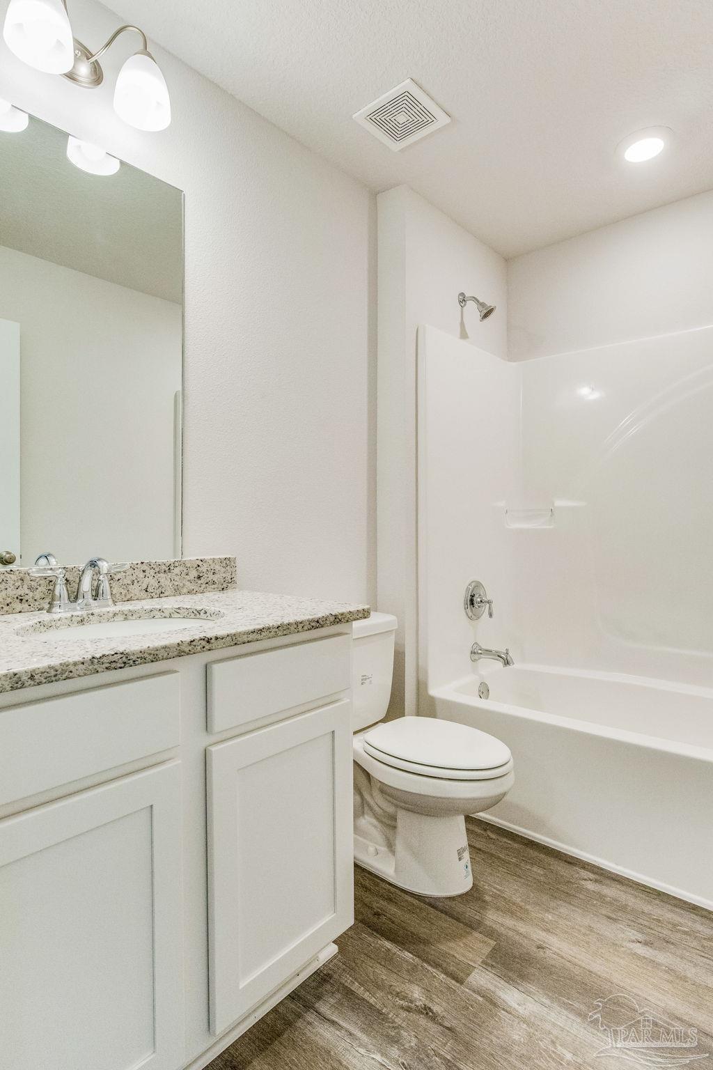 9823 MilleeLoop Loop Pensacola, FL 32526 - Photo 19 of 50 a bathroom with a granite countertop toilet a sink and a bathtub