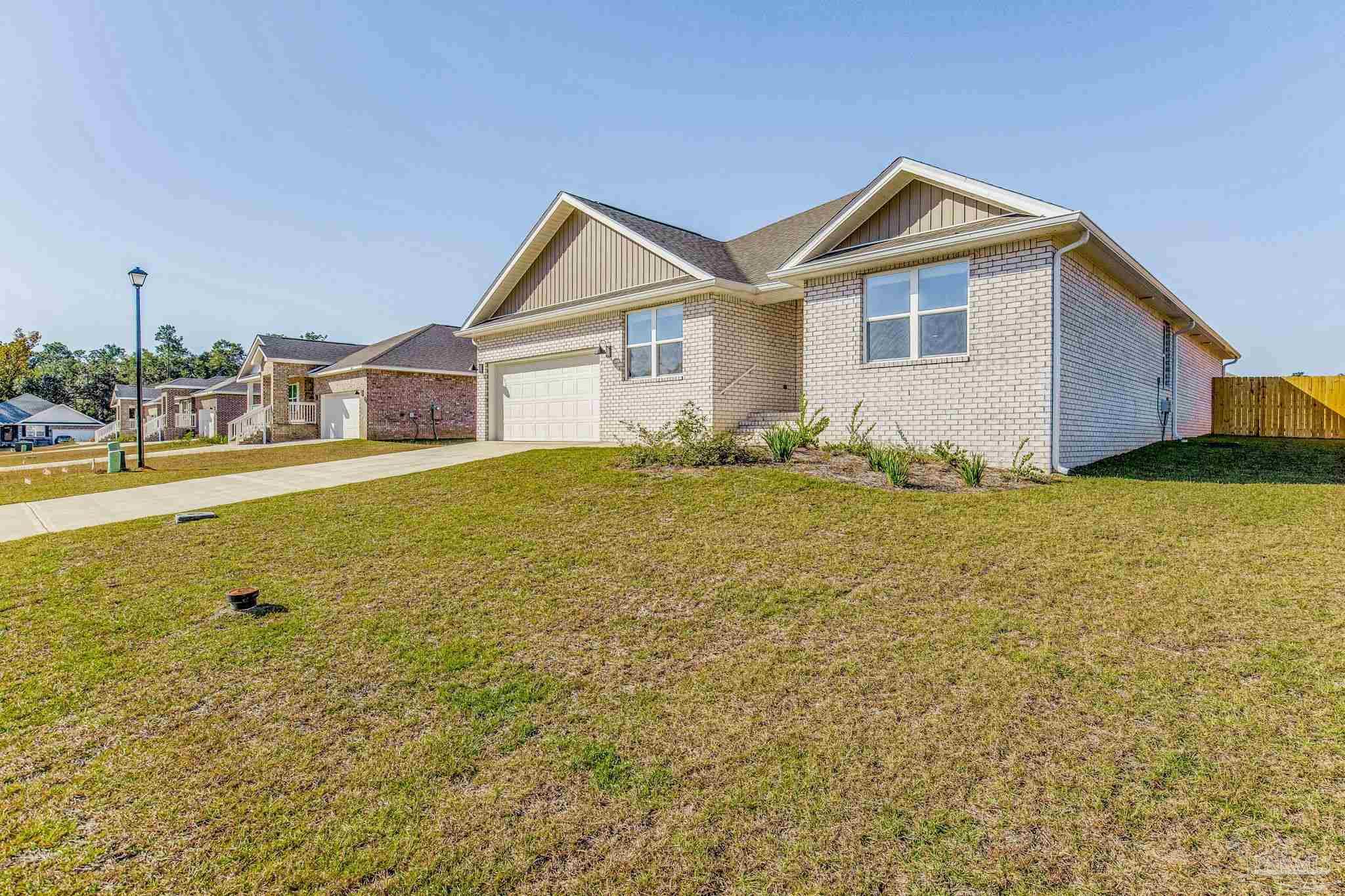 9823 MilleeLoop Loop Pensacola, FL 32526 - Photo 2 of 50 a view of an house with backyard and garden