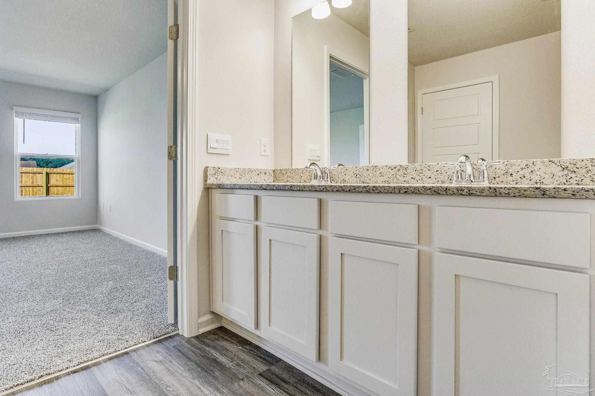 9823 MilleeLoop Loop Pensacola, FL 32526 - Photo 25 of 50 a bathroom with a granite countertop sink and a mirror