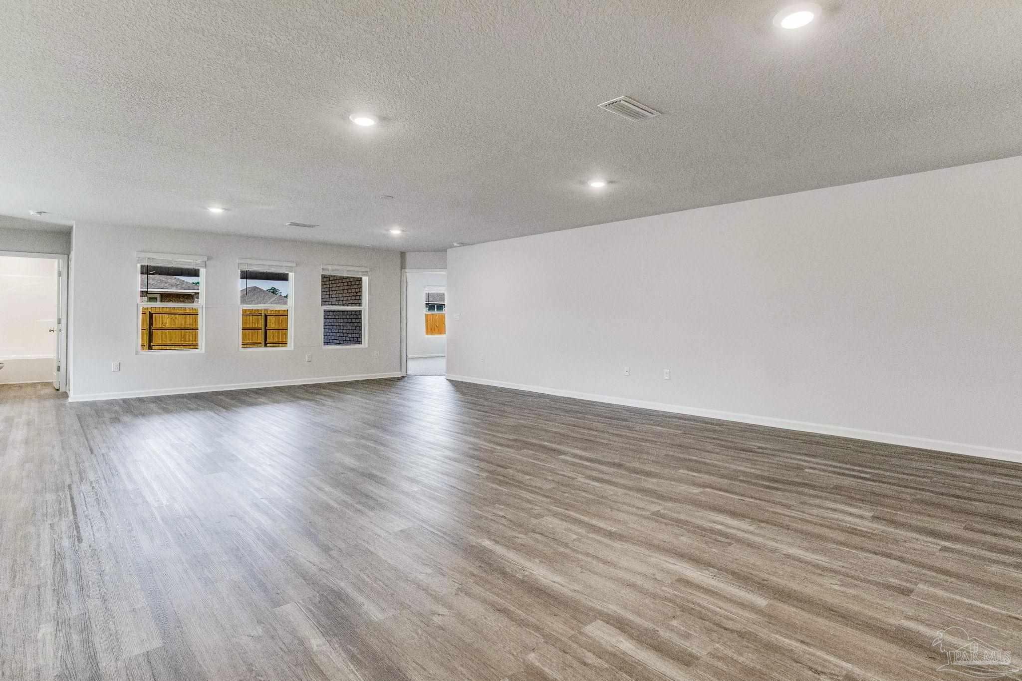 9823 MilleeLoop Loop Pensacola, FL 32526 - Photo 3 of 50 a view of an empty room with wooden floor and a window
