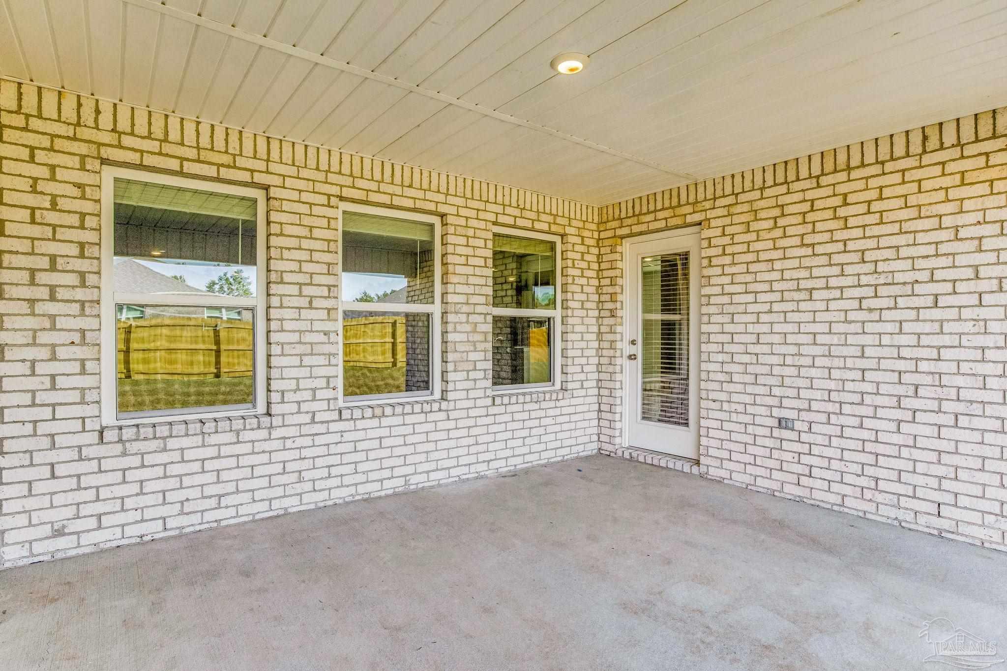 9823 MilleeLoop Loop Pensacola, FL 32526 - Photo 42 of 50 a view of a brick house with many windows