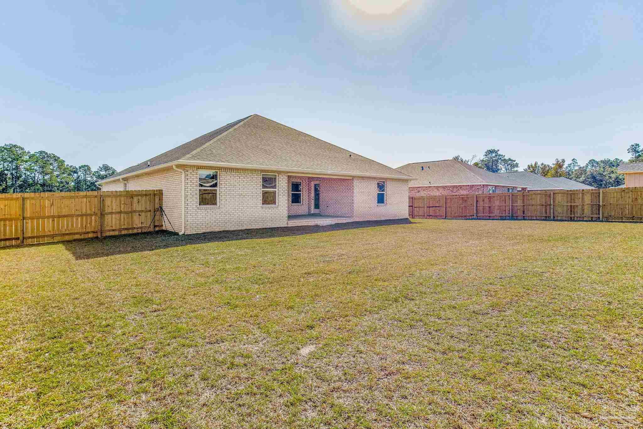 9823 MilleeLoop Loop Pensacola, FL 32526 - Photo 48 of 50 a view of a house with a yard and a large tree