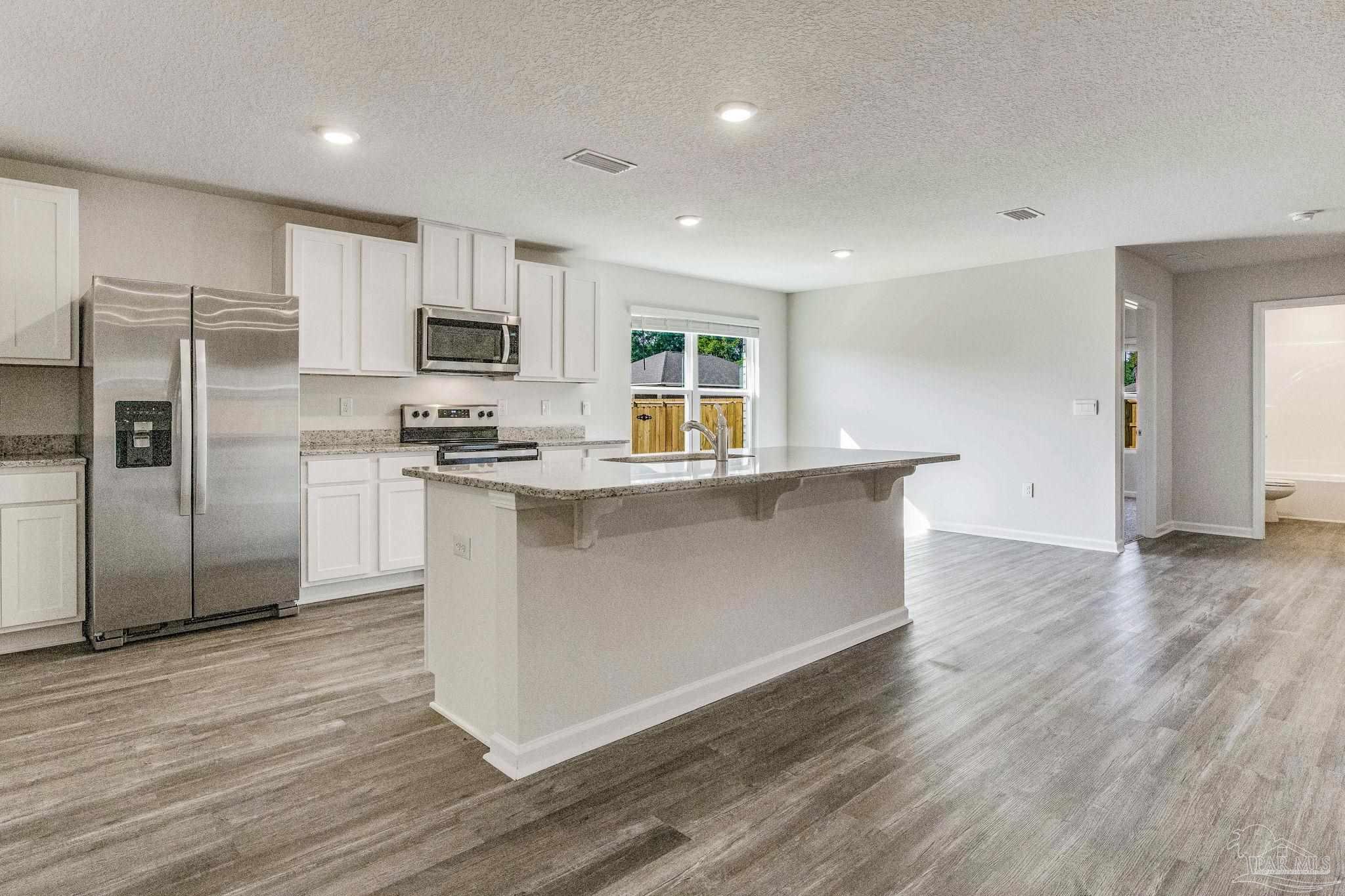 9823 MilleeLoop Loop Pensacola, FL 32526 - Photo 5 of 50 a kitchen with stainless steel appliances a refrigerator and a stove top oven