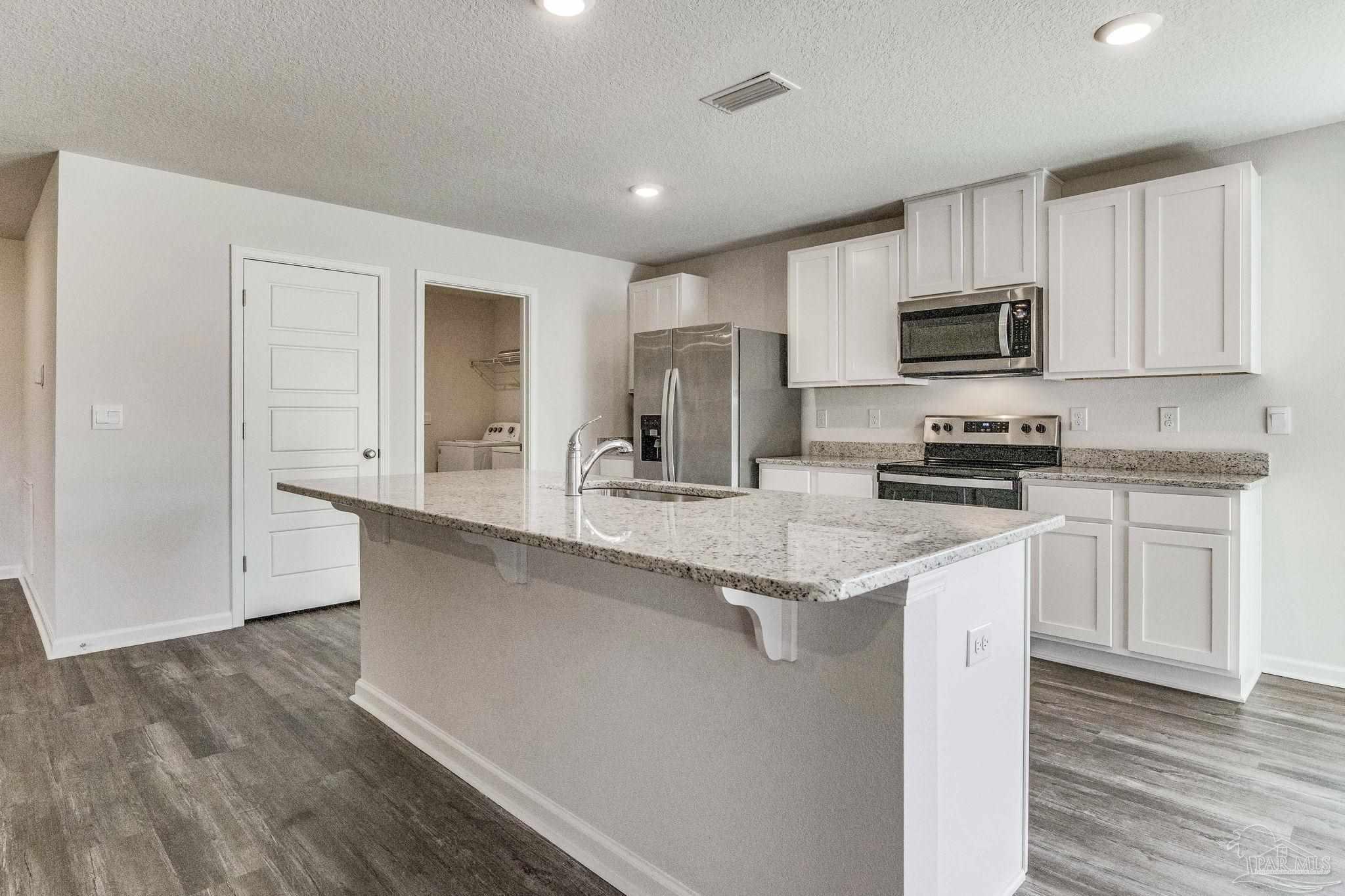 9823 MilleeLoop Loop Pensacola, FL 32526 - Photo 6 of 50 a kitchen with stainless steel appliances granite countertop a stove a sink and a microwave