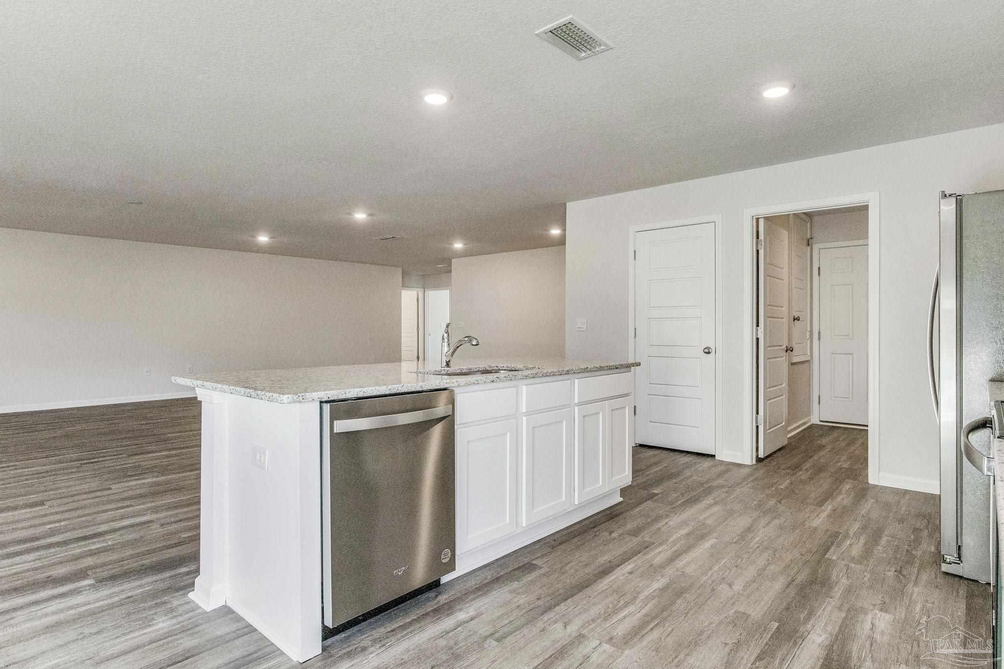 9823 MilleeLoop Loop Pensacola, FL 32526 - Photo 7 of 50 a large kitchen with a lot of counter space and wooden floor