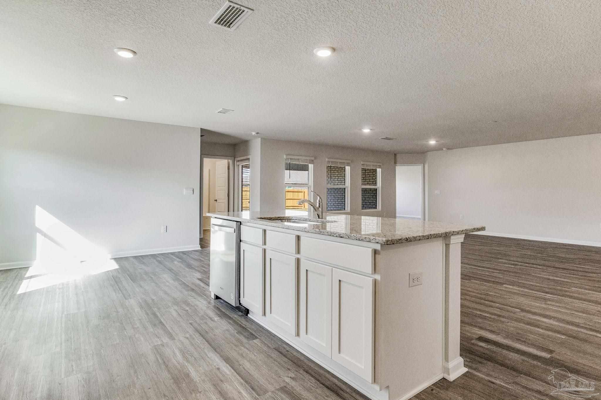9823 MilleeLoop Loop Pensacola, FL 32526 - Photo 8 of 50 a kitchen with granite countertop a sink and cabinets