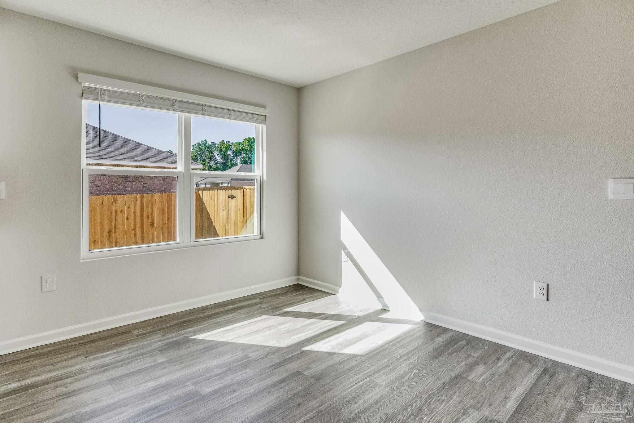 9823 MilleeLoop Loop Pensacola, FL 32526 - Photo 10 of 50 a view of empty room with wooden floor and fan