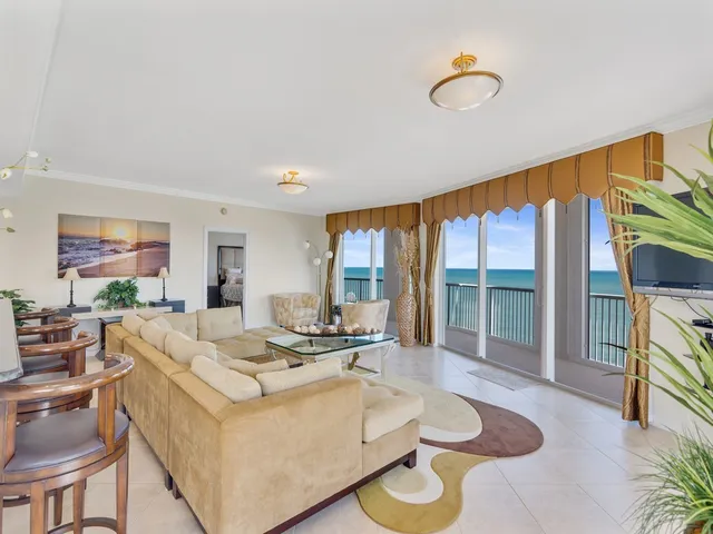a kitchen with granite countertop a sink a counter top space and living room view