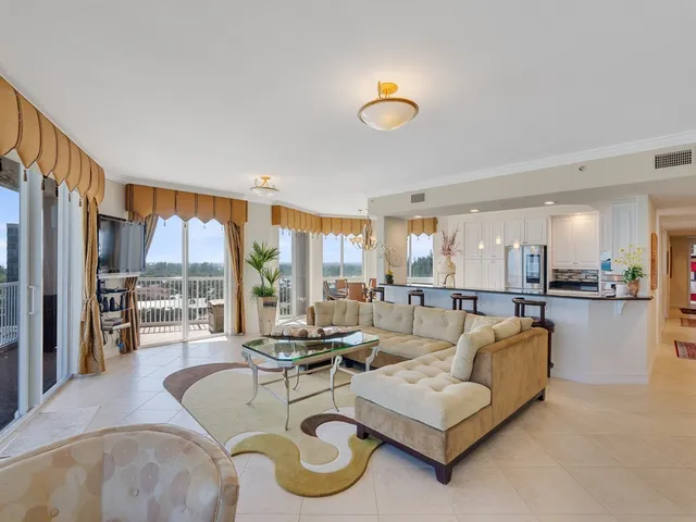 a living room with furniture a rug and a chandelier
