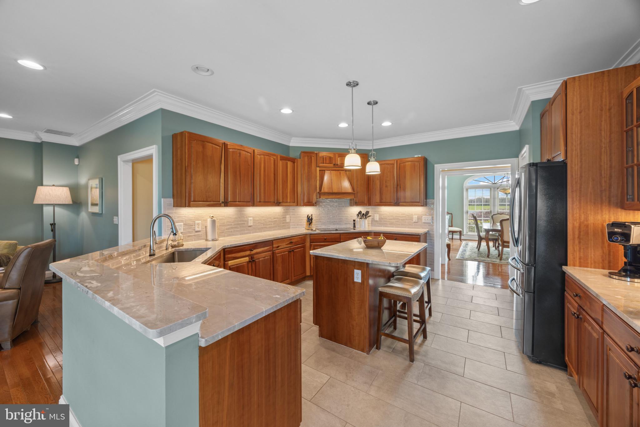 209 Beck Farm Road Centreville, MD 21617 - Photo 13 of 55 a kitchen with stainless steel appliances granite countertop a sink counter space and a stove top oven