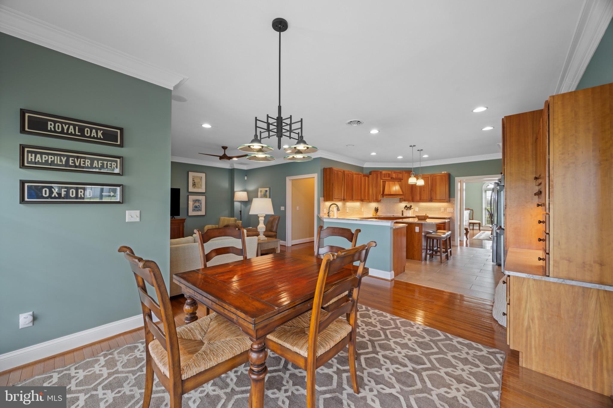 209 Beck Farm Road Centreville, MD 21617 - Photo 14 of 55 a dining room with furniture a chandelier and wooden floor