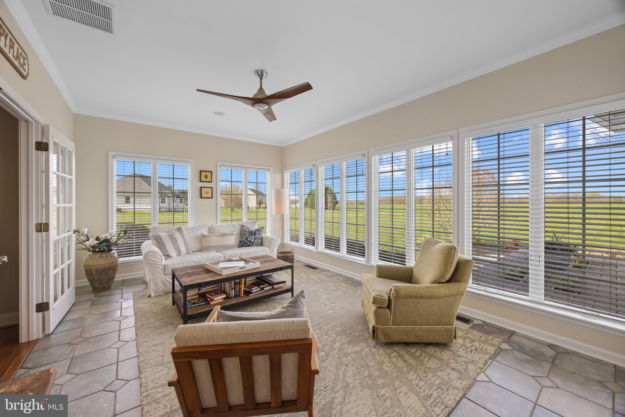 209 Beck Farm Road Centreville, MD 21617 - Photo 18 of 55 a living room with furniture and a floor to ceiling window