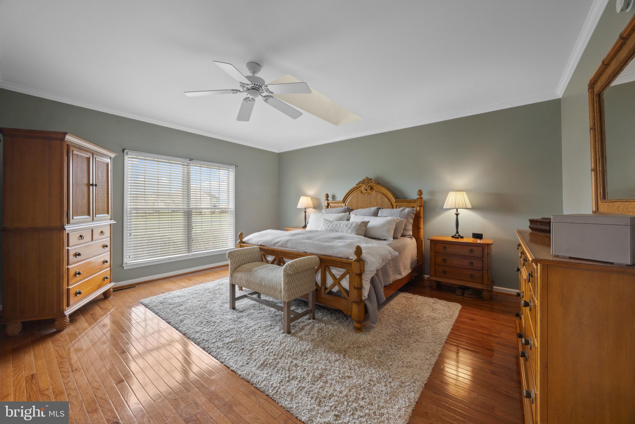 209 Beck Farm Road Centreville, MD 21617 - Photo 26 of 55 a bedroom with a bed and wooden floor