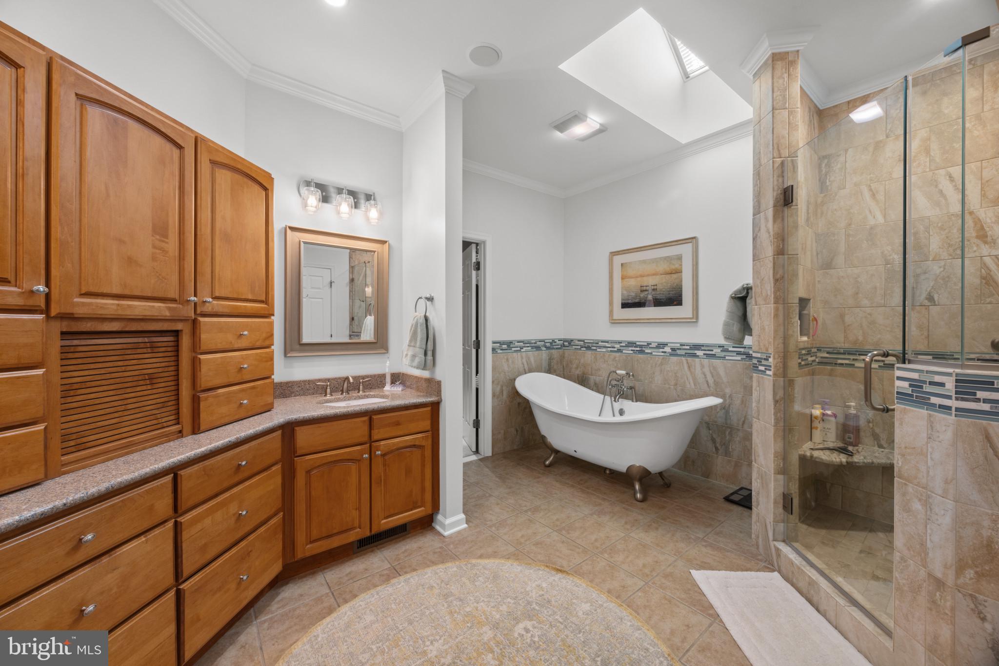 209 Beck Farm Road Centreville, MD 21617 - Photo 28 of 55 a spacious bathroom with a double vanity sink a mirror and a bathtub
