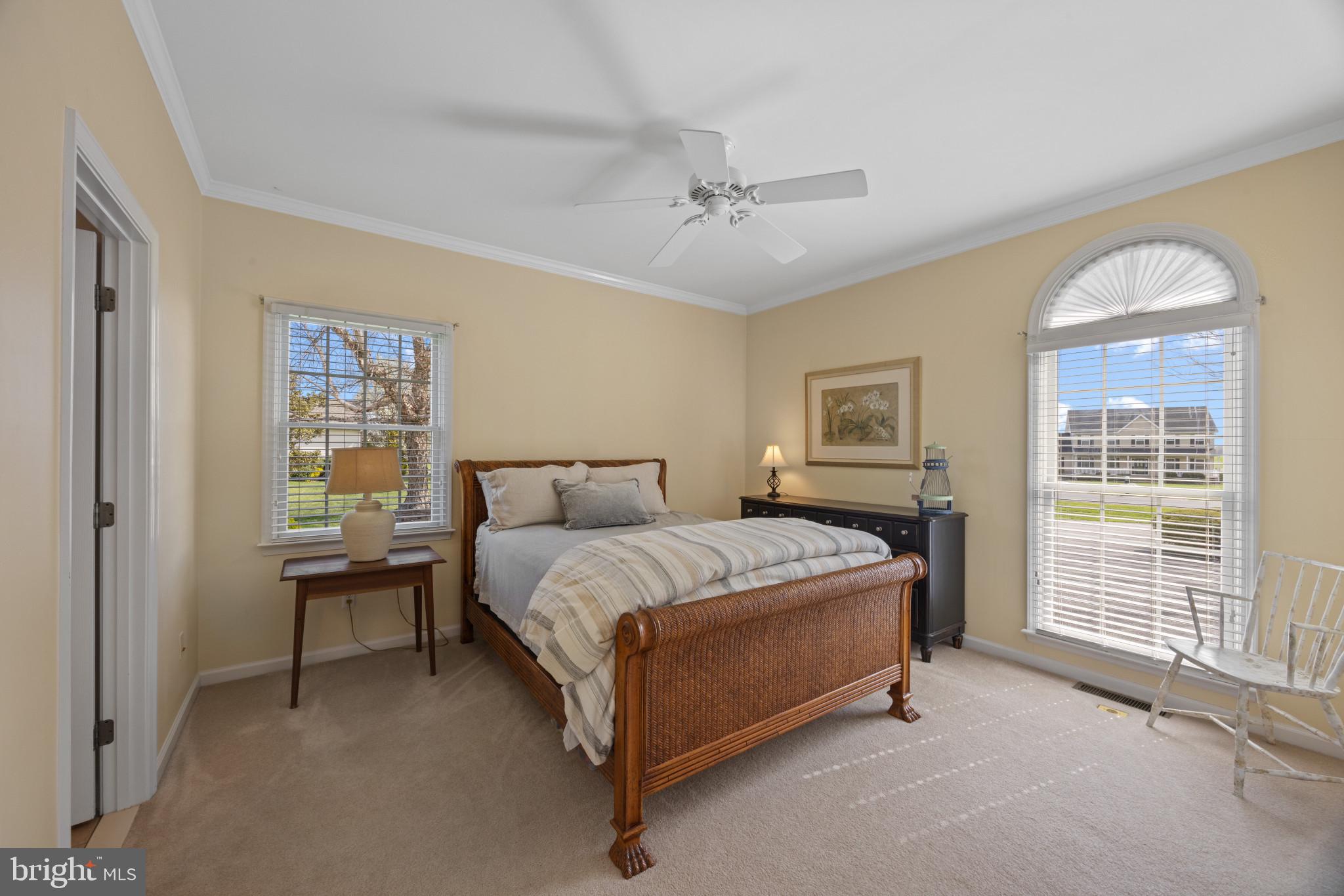 209 Beck Farm Road Centreville, MD 21617 - Photo 30 of 55 a spacious bedroom with a bed and a chandelier