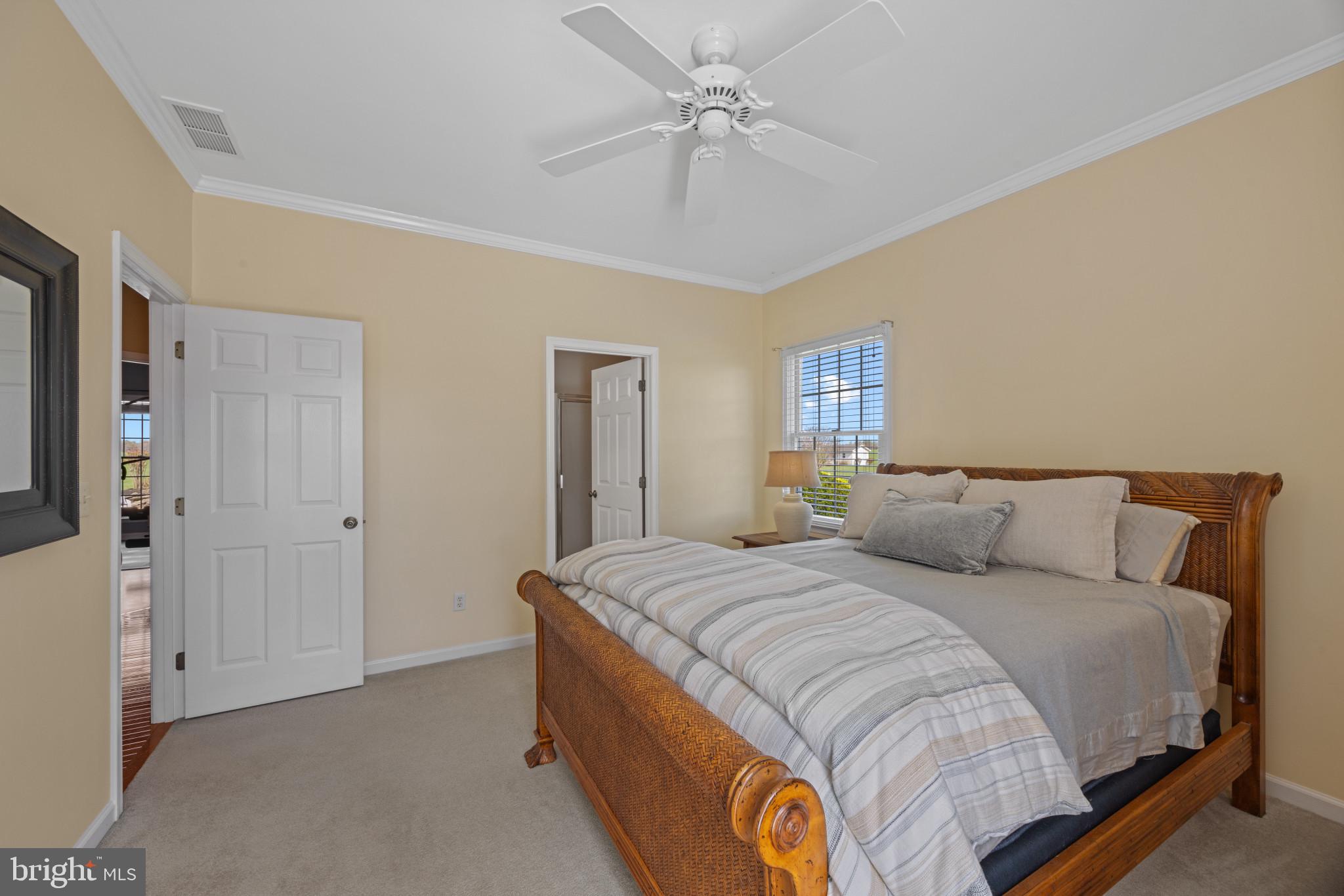 209 Beck Farm Road Centreville, MD 21617 - Photo 31 of 55 a large bedroom with a bed and a chandelier