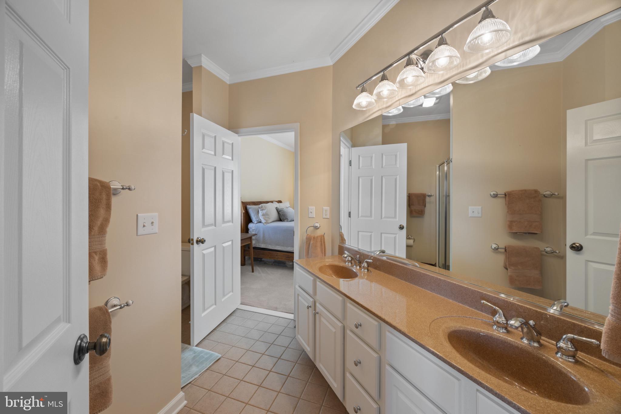 209 Beck Farm Road Centreville, MD 21617 - Photo 33 of 55 a spacious bathroom with a double vanity sink a mirror and shower