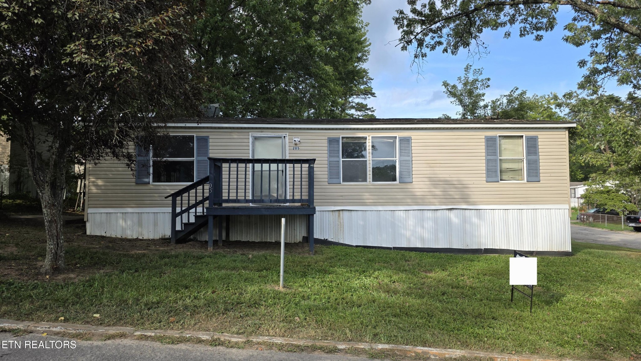 a front view of a house with a garden and deck
