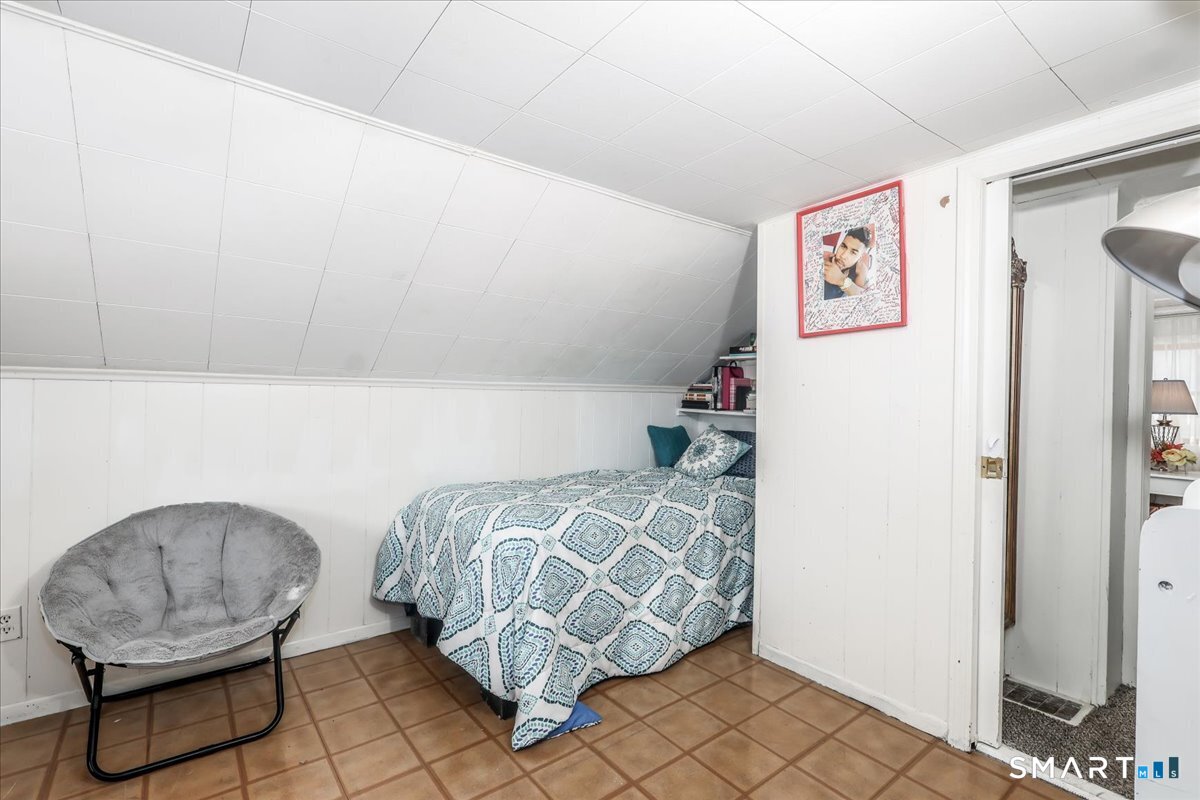 306 Welton Street Hamden, CT 06517 - Photo 26 of 38 a bedroom with a bed and a chair in it
