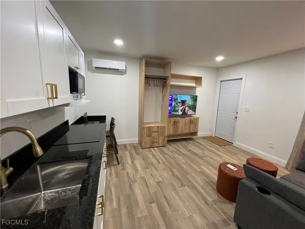 a living room with furniture and a wooden floor