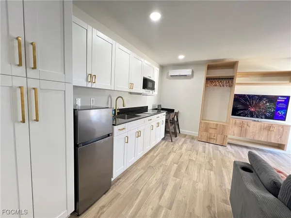 a kitchen with stainless steel appliances a refrigerator sink and cabinets
