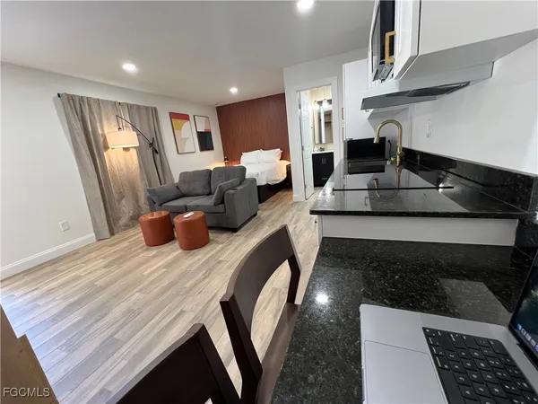 a kitchen with stainless steel appliances granite countertop a stove a sink and a refrigerator