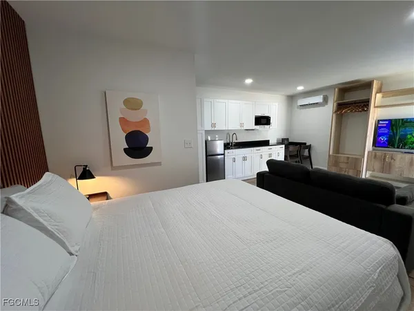 a bedroom with a bed and cabinets