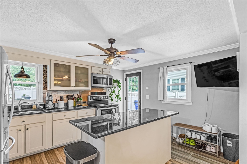 6 Baird Trace Springfield, MA 01118 - Photo 7 of 27 a kitchen with stainless steel appliances granite countertop a sink stove and microwave