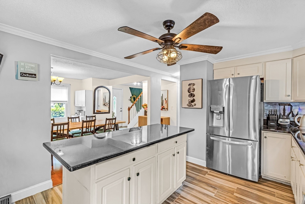 6 Baird Trace Springfield, MA 01118 - Photo 8 of 27 a kitchen with a refrigerator a sink and a chandelier