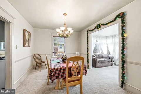 a dining room with furniture and chandelier