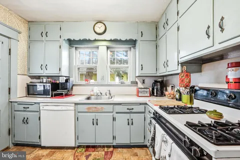 a kitchen with cabinets window and stainless steel appliances