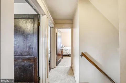 a view of a hallway with furniture and closet
