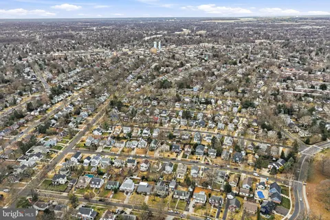 an aerial view of residential houses with city view