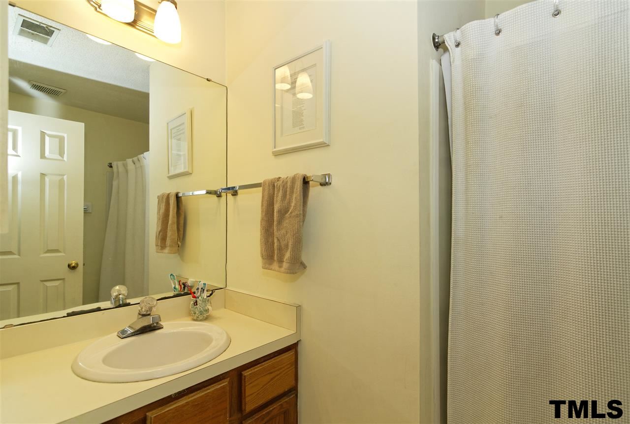 1454 Barton Pl Drive Raleigh, NC 27608 - Photo 16 of 25 a bathroom with a sink and a mirror